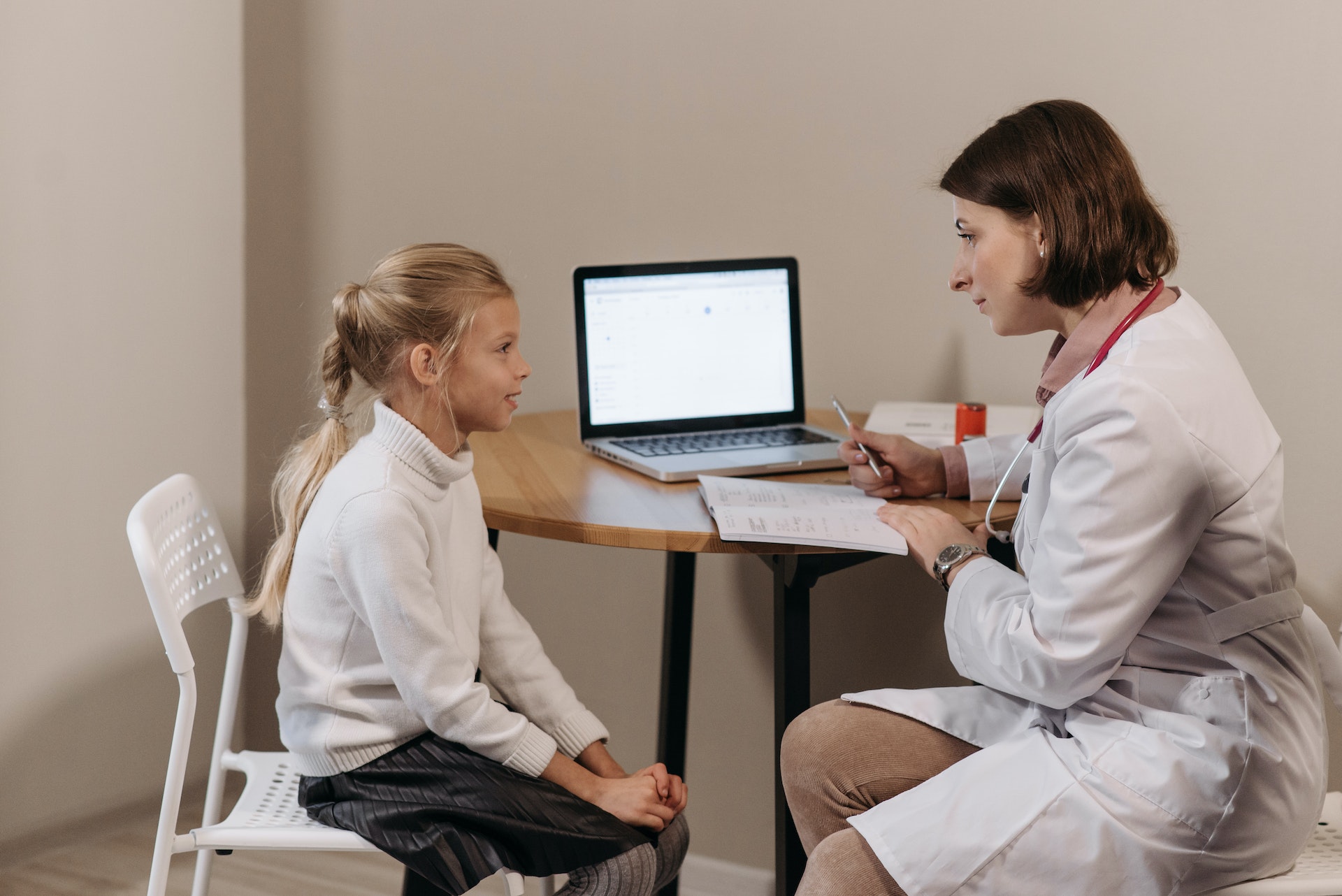 doctor in white lab coat and girl patient