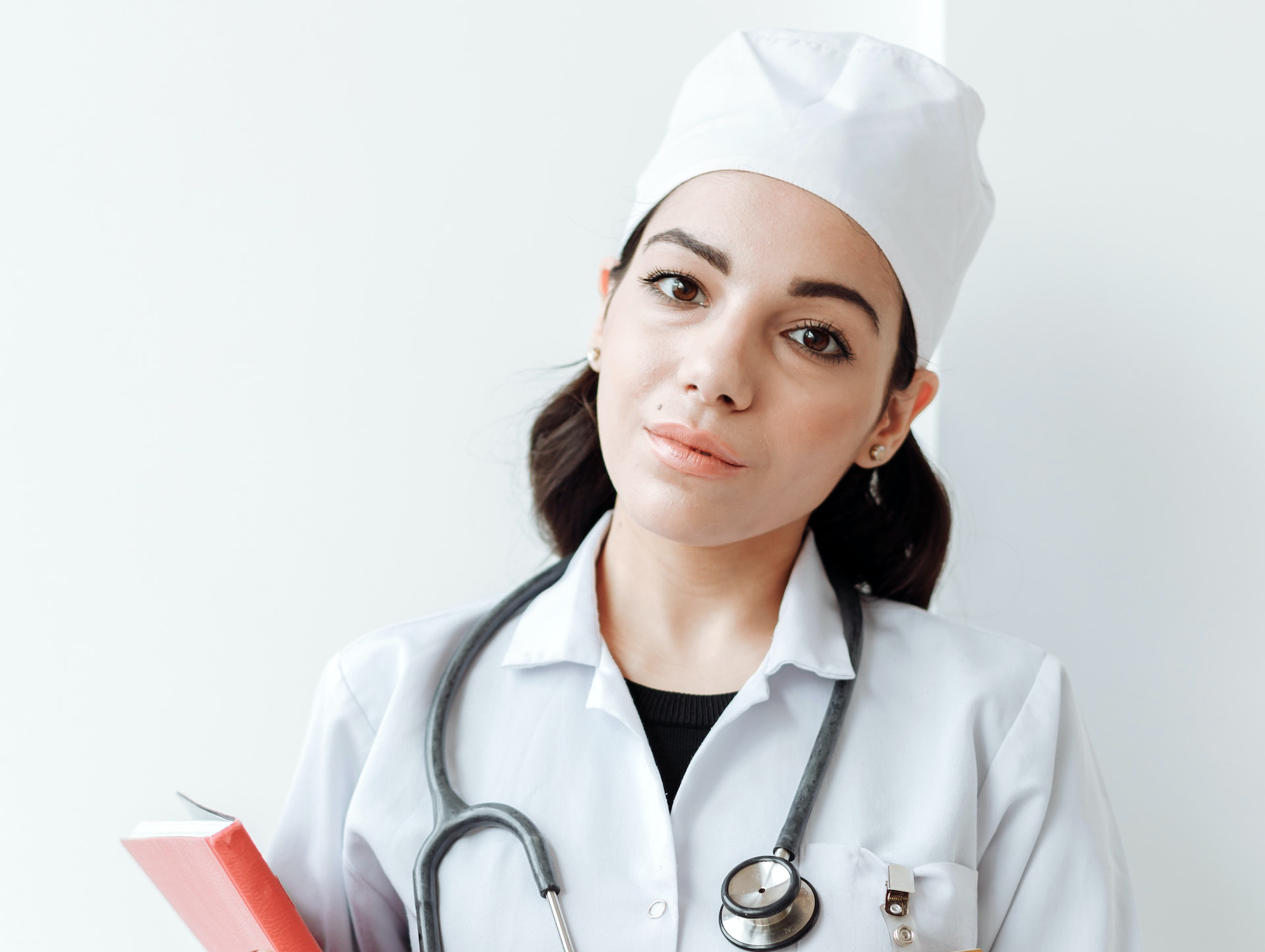 healthcare professional in white uniform with-stethoscope hanging on her neck