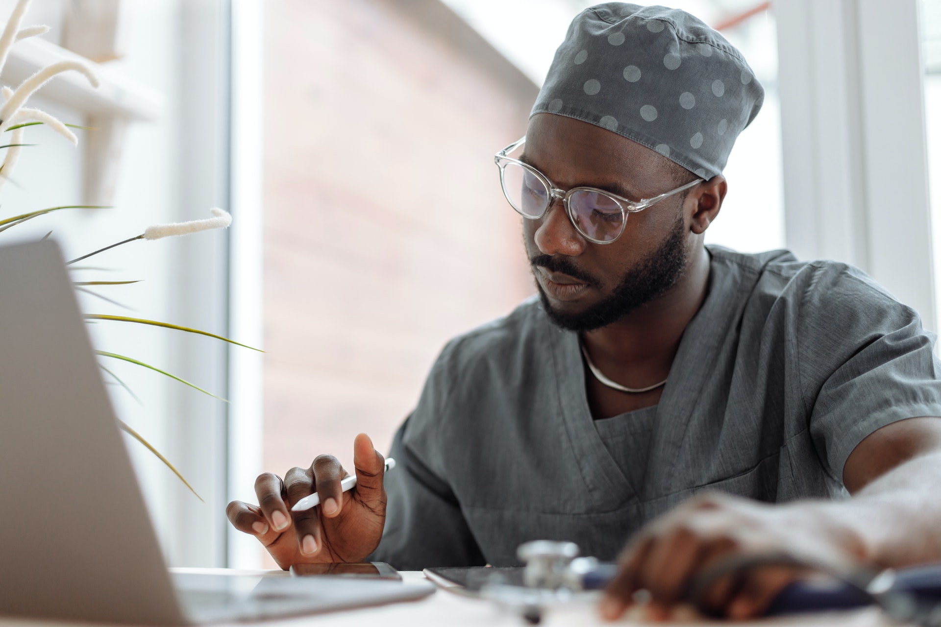 A medical practitioner using electronic gadgets at work