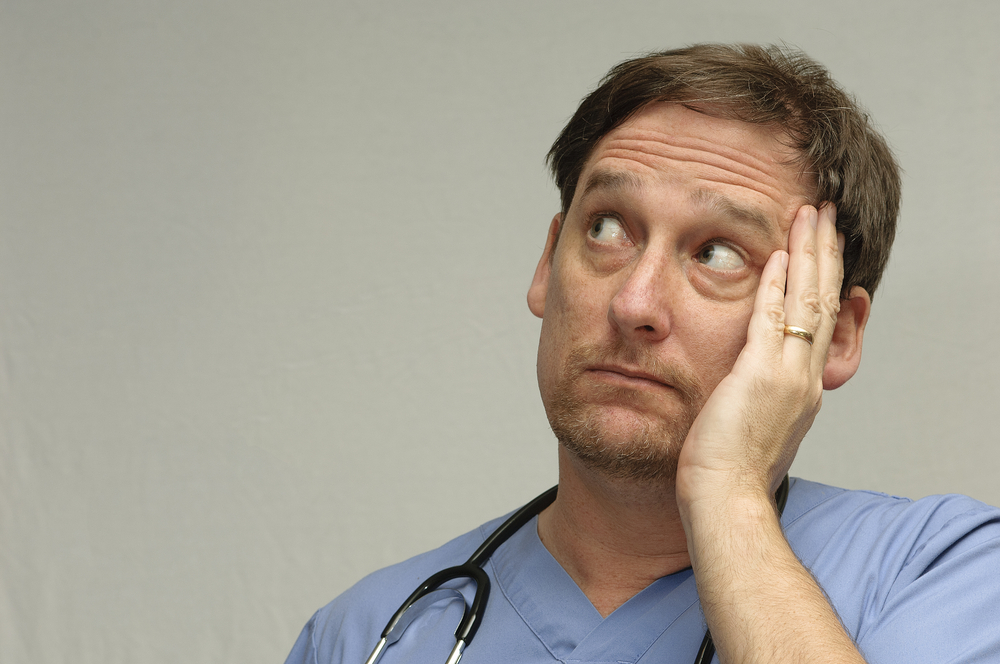 Worried Male Nurse in uniform looking left