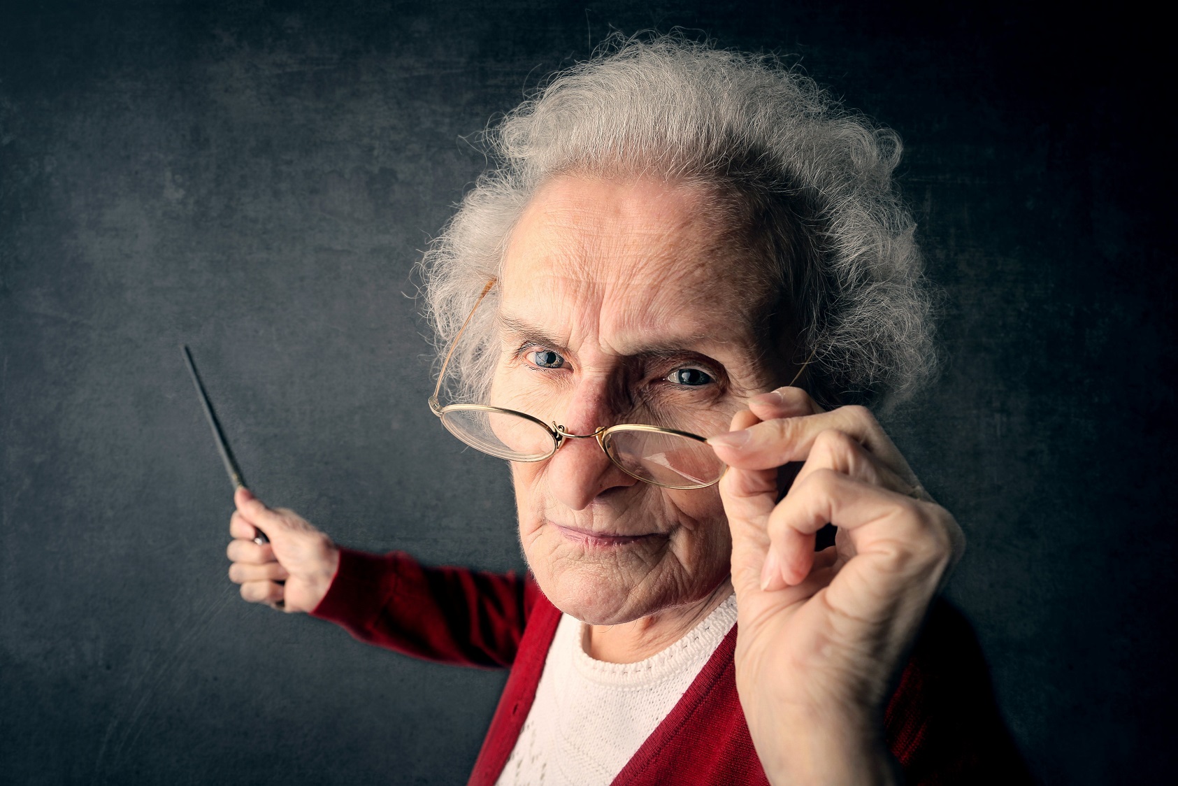 Senior female teacher is looking back with angry face.
