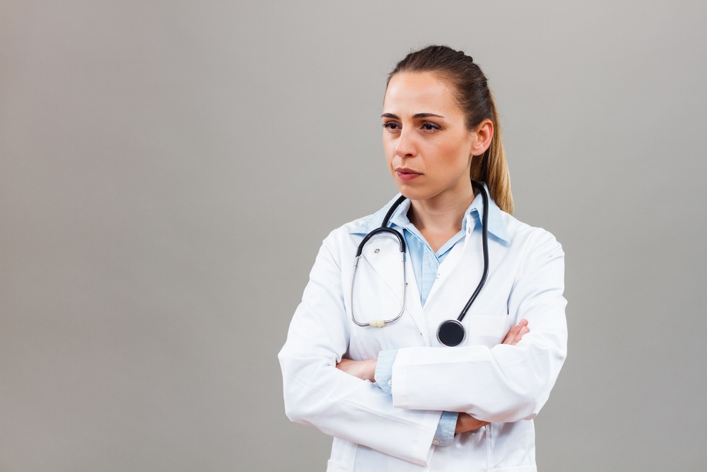 Angry female doctor looking away