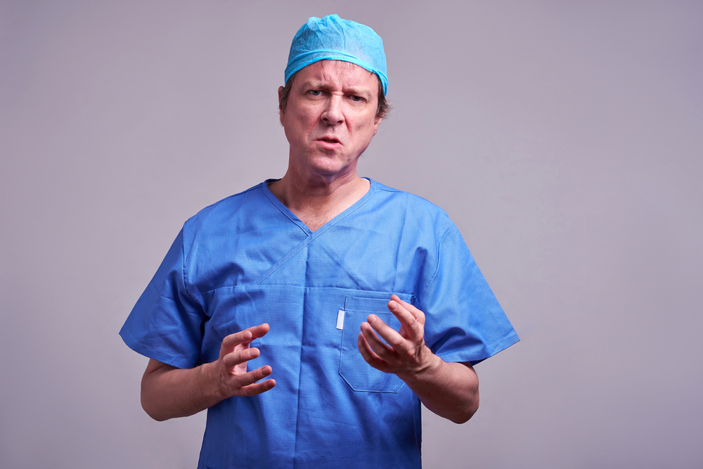 A middle aged male doctor feeling angry