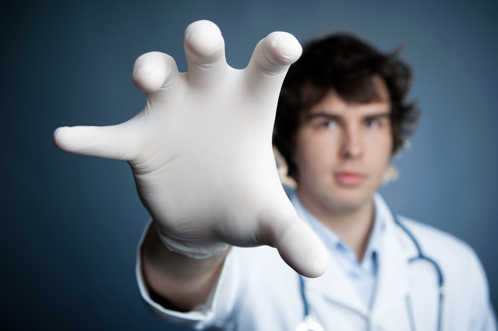 Angry doctor with hand in front of him trying to grab something