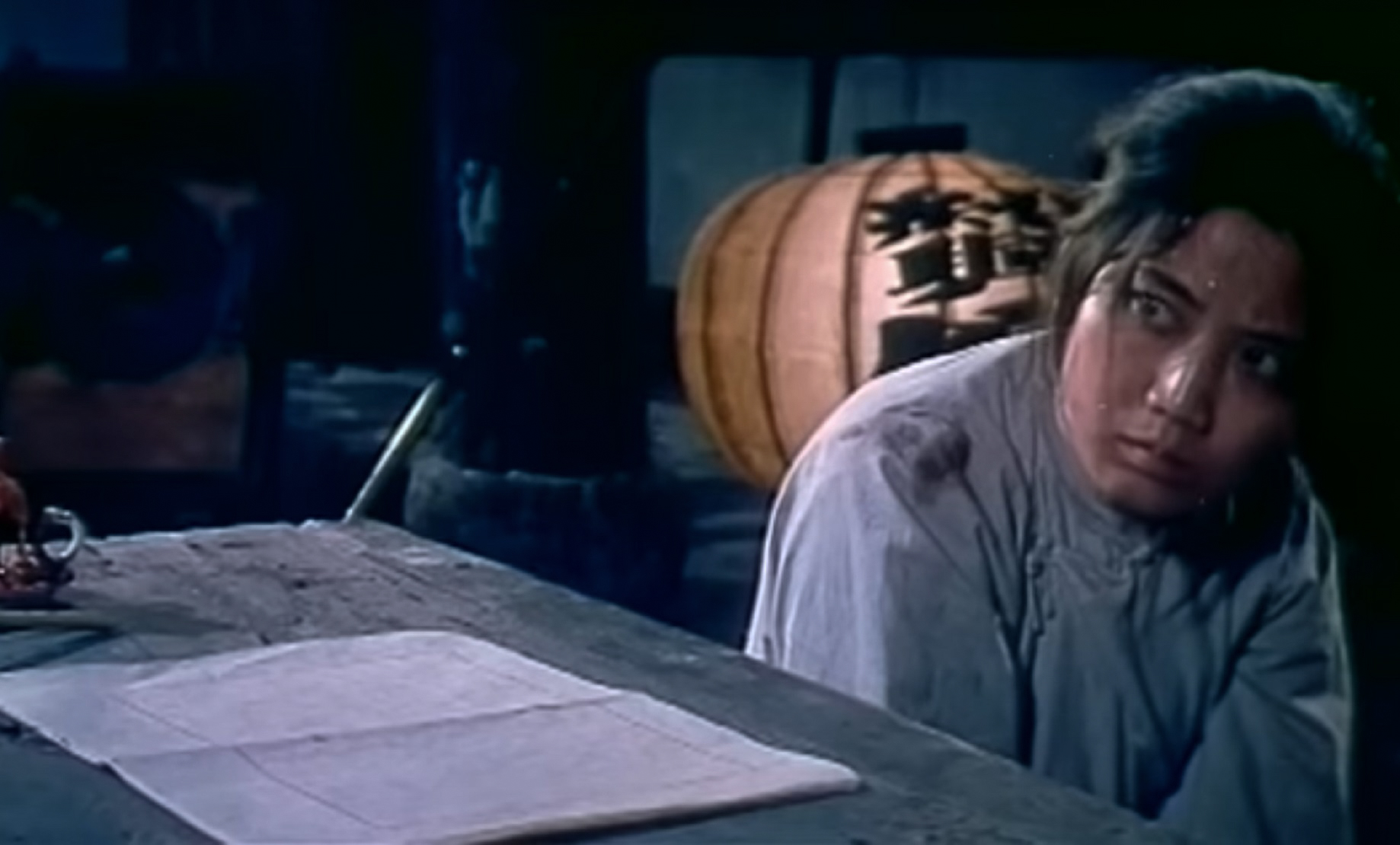 Screenshot: Qiu Jin (Xiuming Li) is looking at side wearing white shirt - from Qiu Jin (1983)