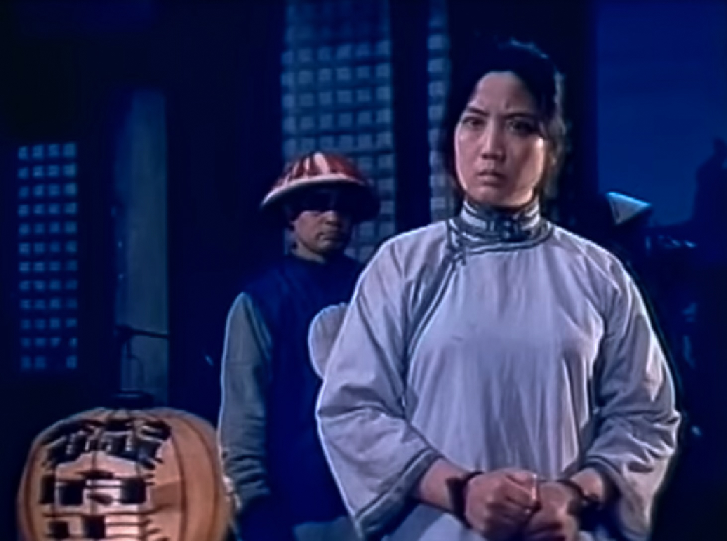 Screenshot: Qiu Jin (Xiuming Li) wearing handcuffs is looking at front with angry face - from Qiu Jin (1983)
