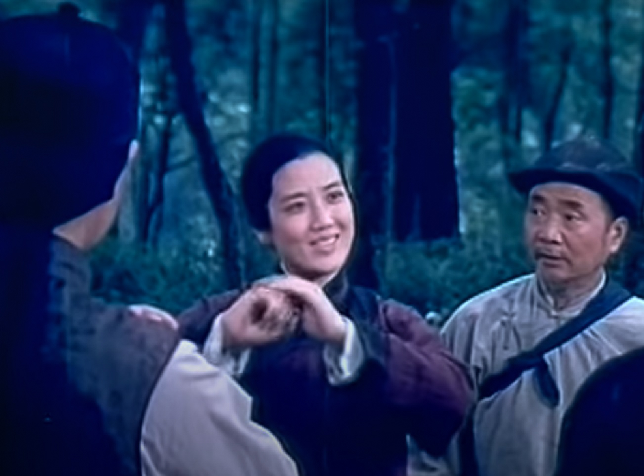 Screenshot: Qiu Jin (Xiuming Li) is standing next to other people outside ,looking happy - from Qiu Jin (1983)
