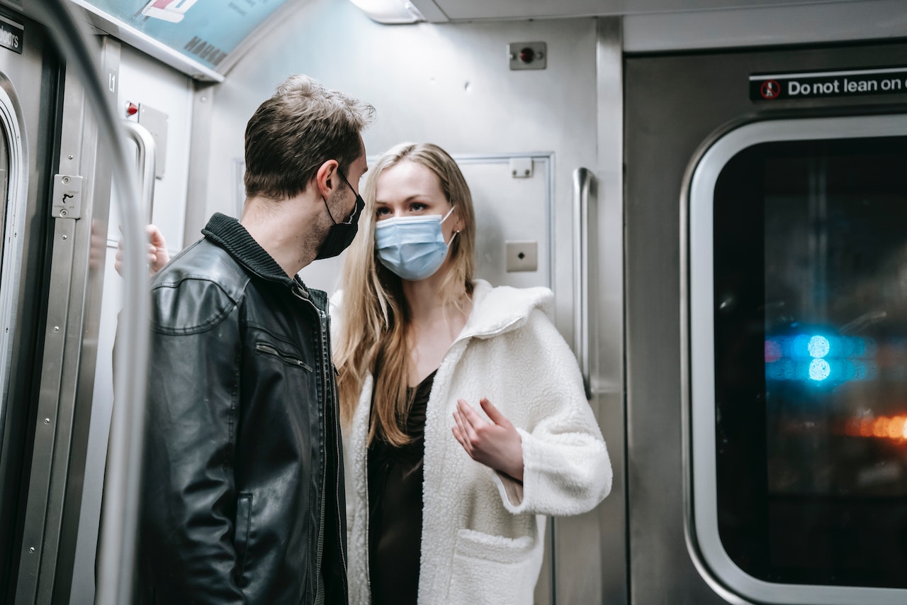 Two people are having a conversation while riding in train.