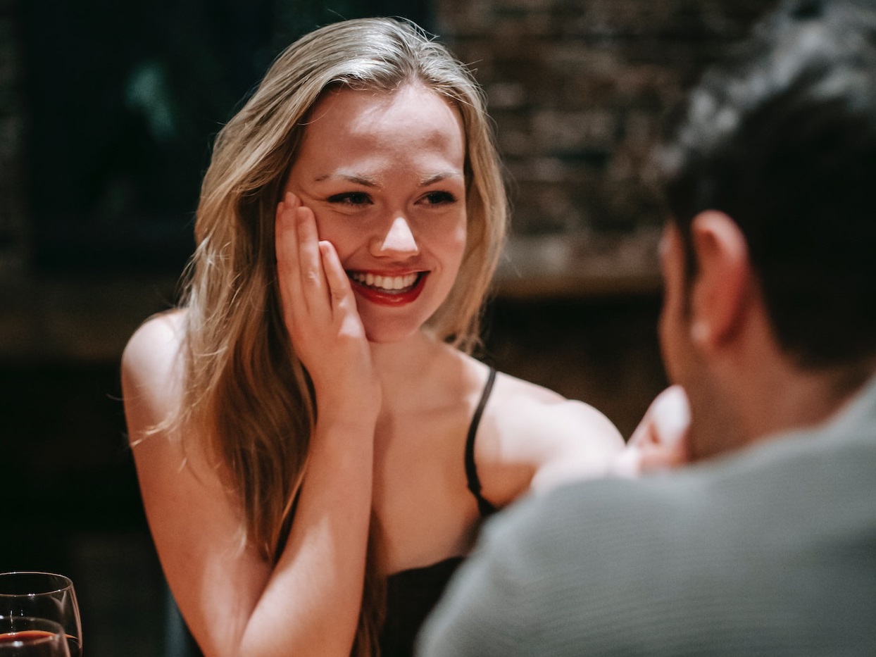 Woman is having a dinner with young male at restaurant.