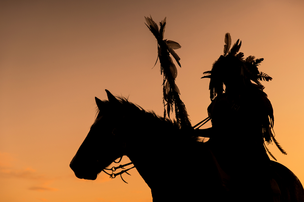 Silhouette of a Native American riding a horse