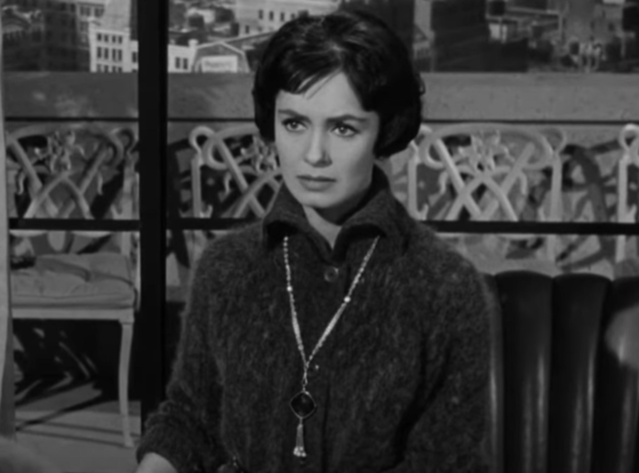 Screenshot: Susan Cabot wearing necklace is looking upset - from The Wasp Woman (1959).