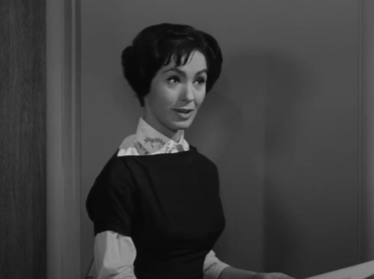 Screenshot: Susan Cabot is talking and looking at side - from The Wasp Woman (1959).