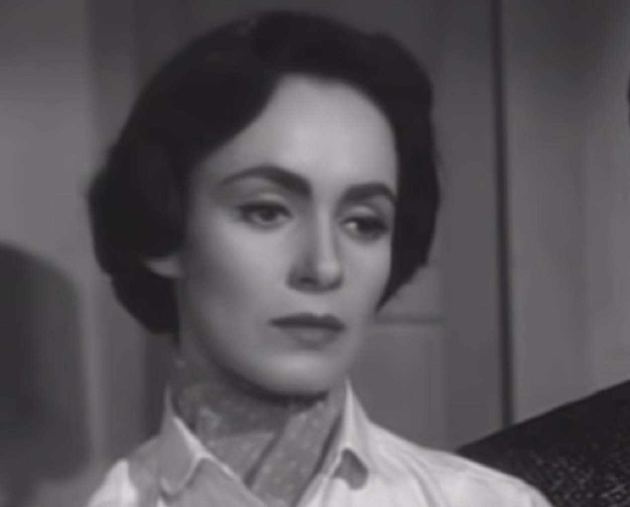 Screenshot: Susan Cabot wearing white shirt is looking sad - from War Of The Satellites (1958).