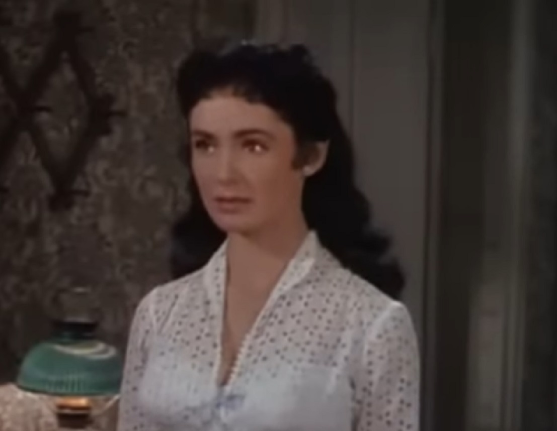 Screenshot: Susan Cabot with white shirt is looking at side - from Gunsmoke (1953).