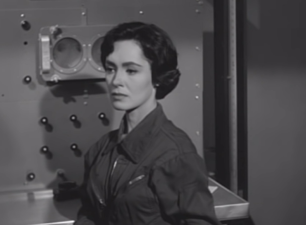 Screenshot: Susan Cabot wearing black shirt is looking at side - from War Of The Satellites (1958).