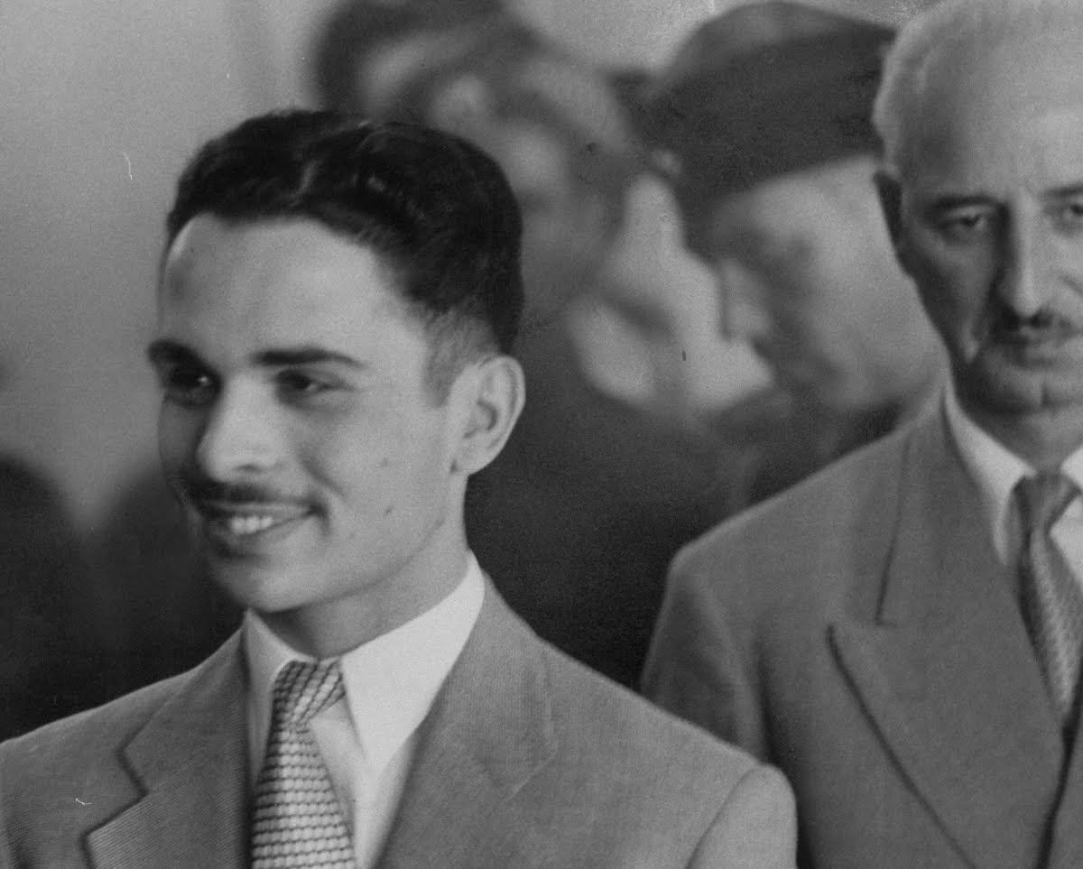 Portrait of King Hussein I of Jordan wearing suit and smiling - 1956