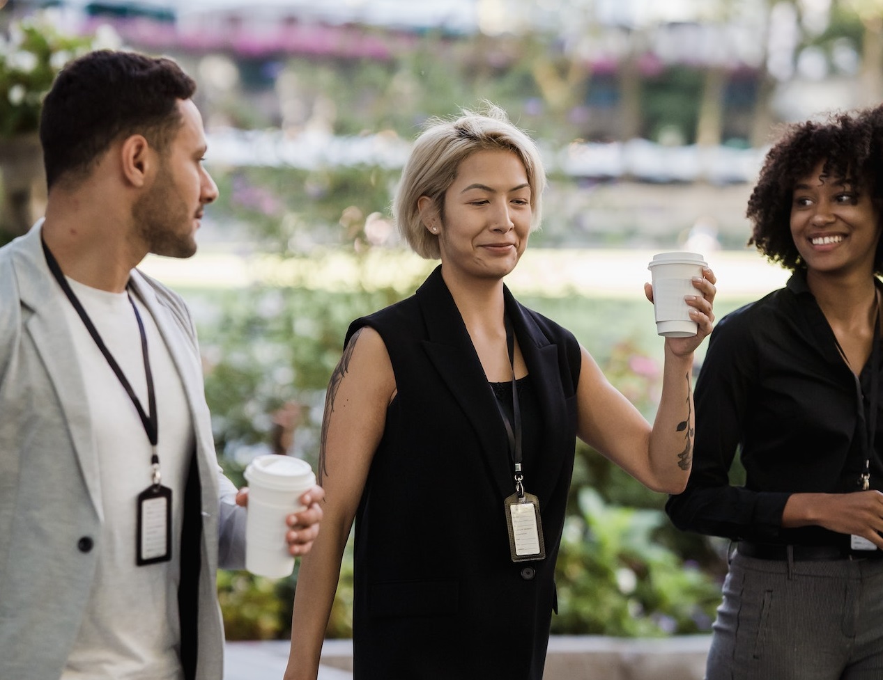Young people are drinking coffee outside.