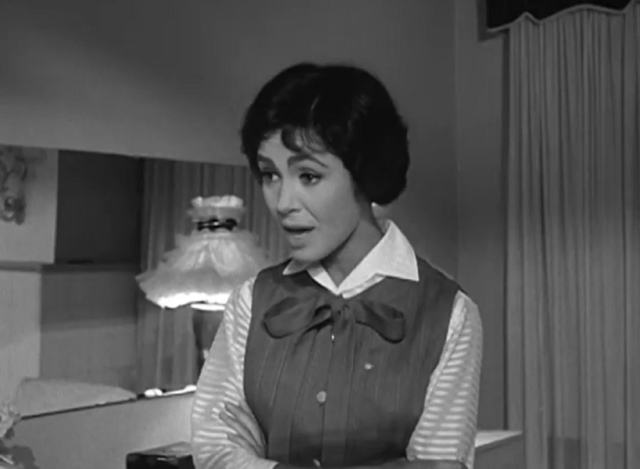 Screenshot: Susan Cabot wearing white shirt and sweater is looking surprised - from Sorority Girl (1957).