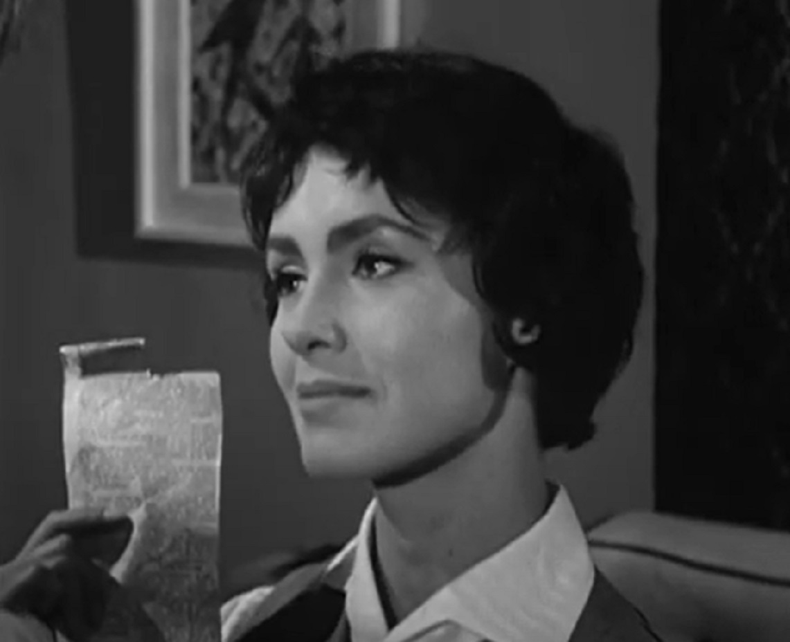 Susan Cabot is looking at side ,holding a letter in her hand - from  Sorority Girl (1957).