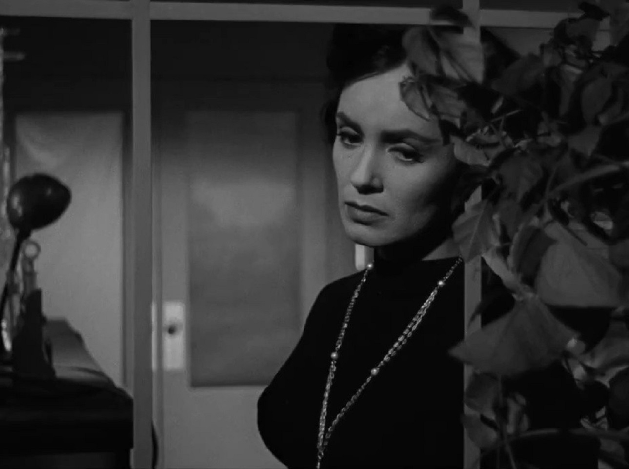 Susan Cabot  wearing black dress is looking sad - from The Wasp Woman (1959)