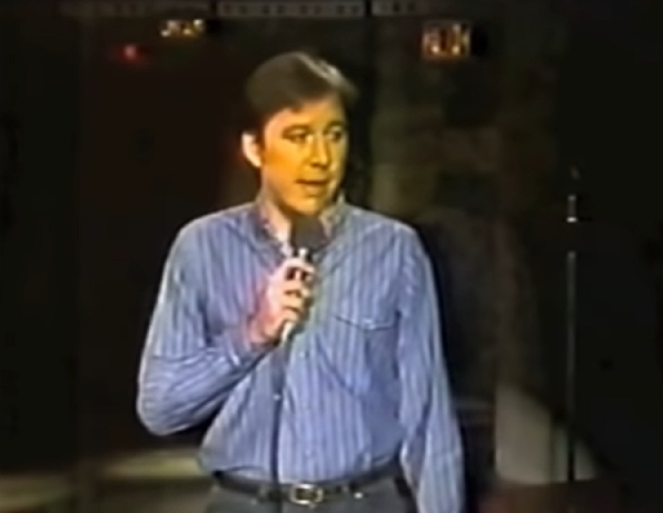 Screenshot: Bill Hicks wearing blue shirt is performing on stage - from Late Night With David Letterman (1982-93)