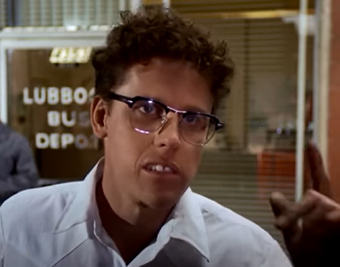 Screenshot: Buddy Holly is looking at side with surprised face - from The Buddy Holly Story (1978).