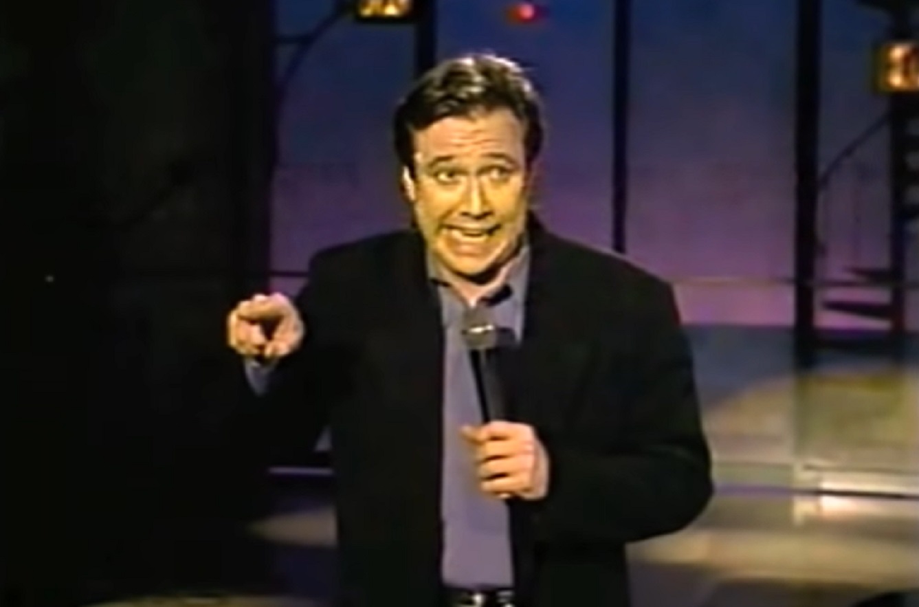 Screenshot: Bill Hicks is looking upset ,performing on stage - from American- The Bill Hicks Story (2009)