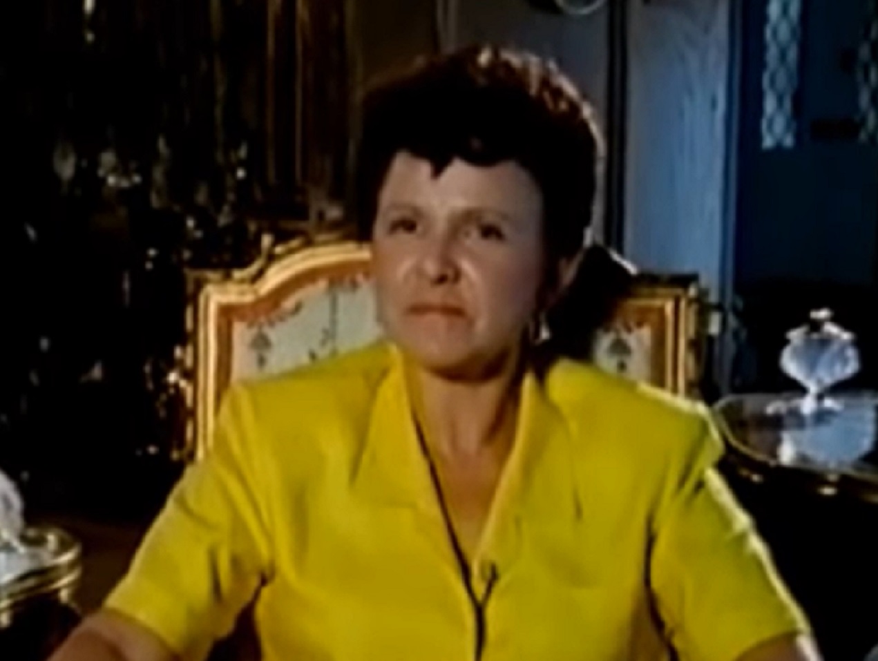 Screenshot: Maria Elena Holly - wearing yellow shirt is looking at side - from The Real Buddy Holly Story (1985)