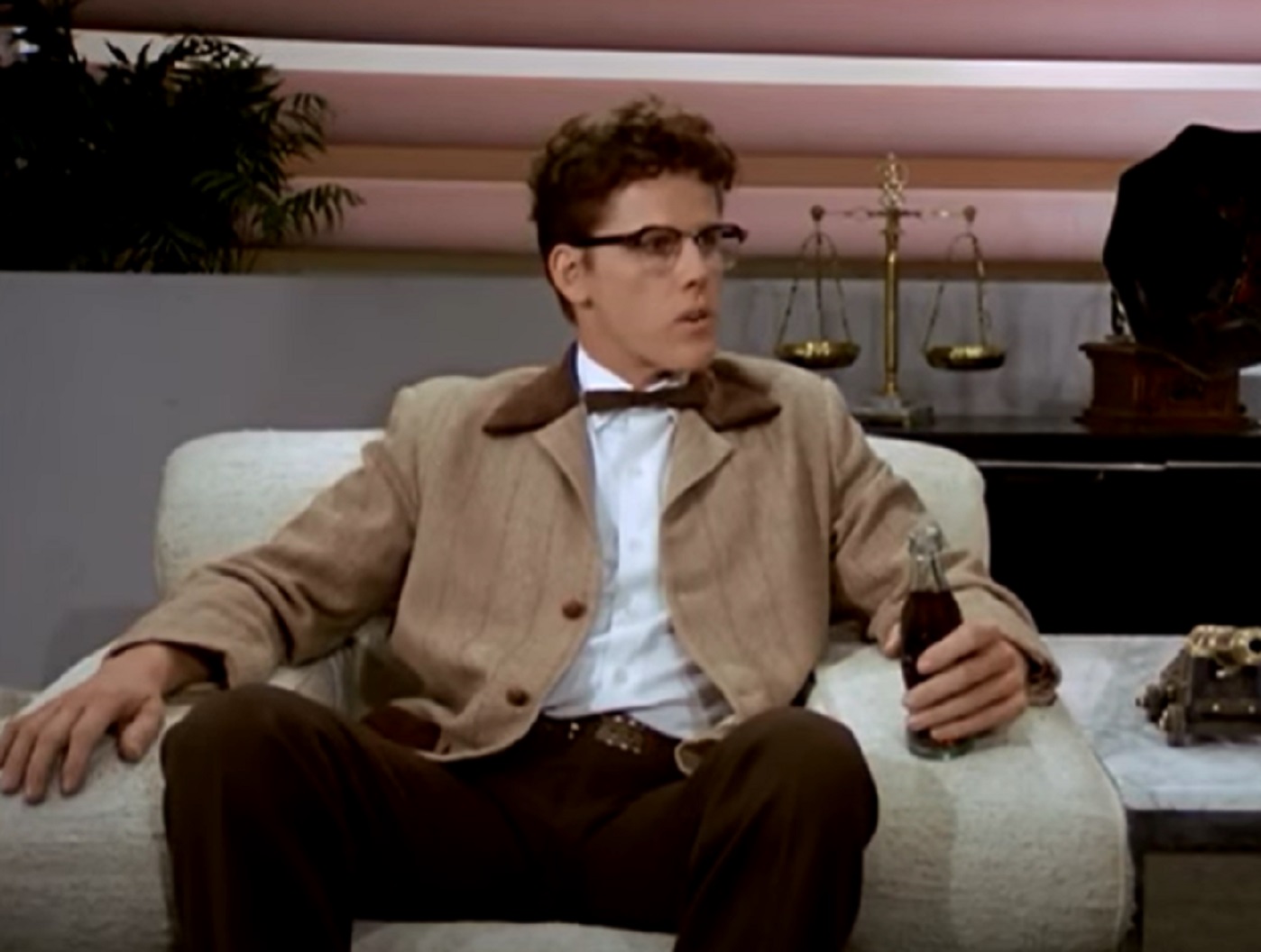Screenshot: Buddy Holly is seating at studio and looking at side - from The Buddy Holly Story (1978)