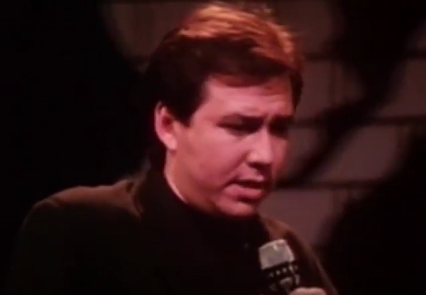 Screenshot: Bill Hicks is performing with sad face - from American- The Bill Hicks Story (2009).