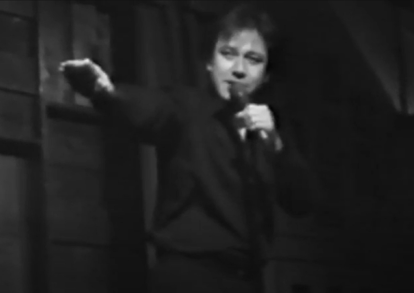 Screenshot: Bill Hicks is performing on stage - from American- The Bill Hicks Story (2009).