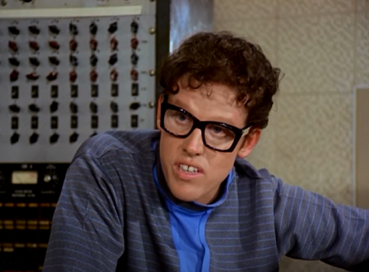 Screenshot: Buddy Holly wearing blue shirt is looking at side - from The Buddy Holly Story (1978).