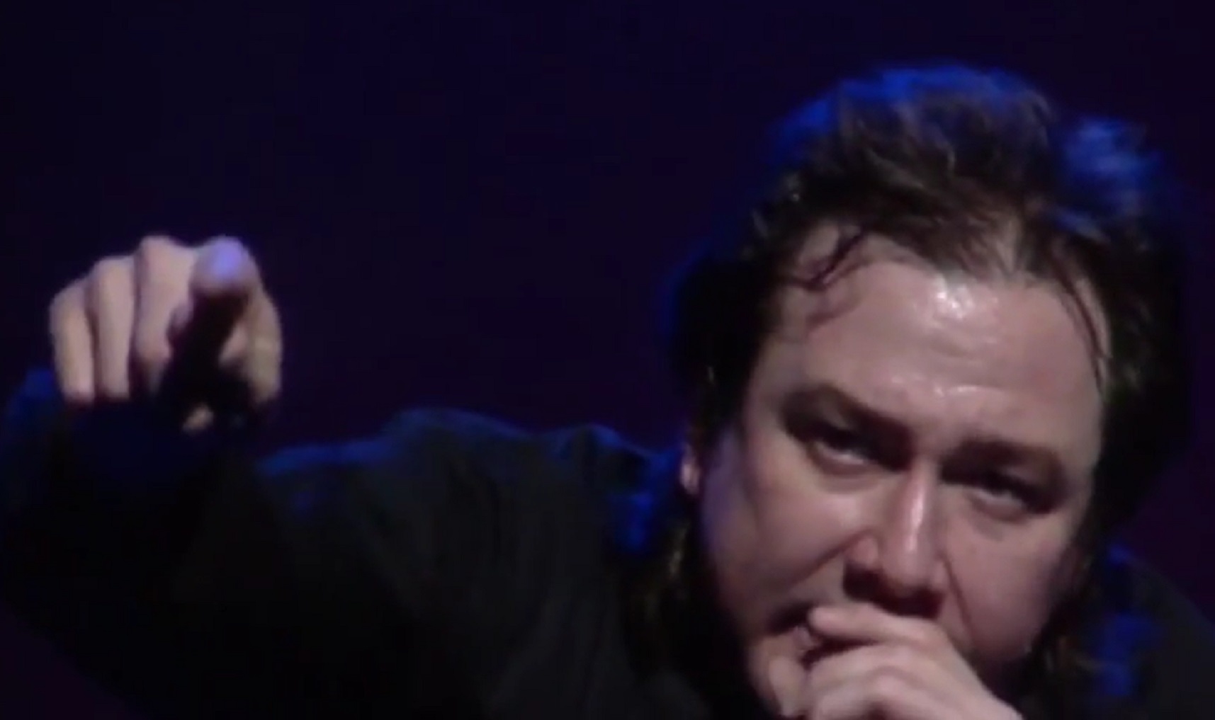 Screenshot: Bill Hicks is having a live performance on stage - from American- The Bill Hicks Story (2009)