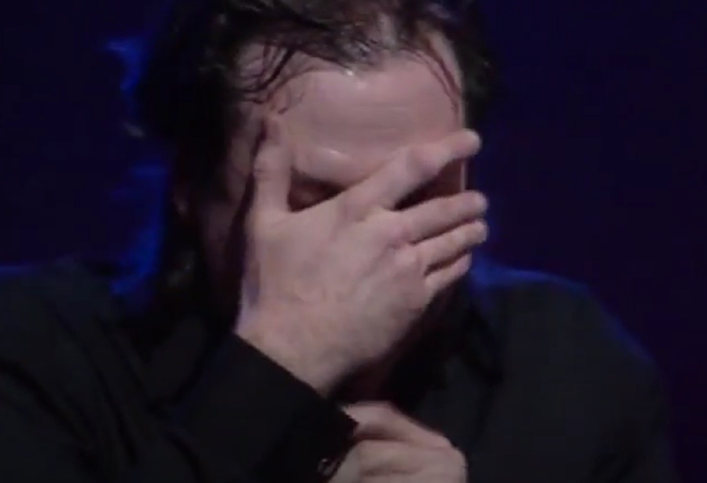 Screenshot: Bill Hicks is covering his face with hand - from Late Night With David Letterman (1982-93).