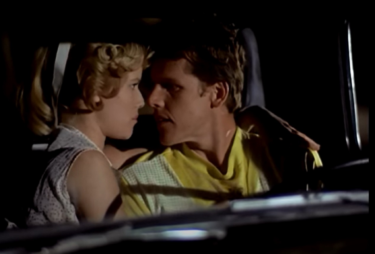 Screenshot: Buddy Holly is talking with a girl in the car  - from The Buddy Holly Story (1978).
