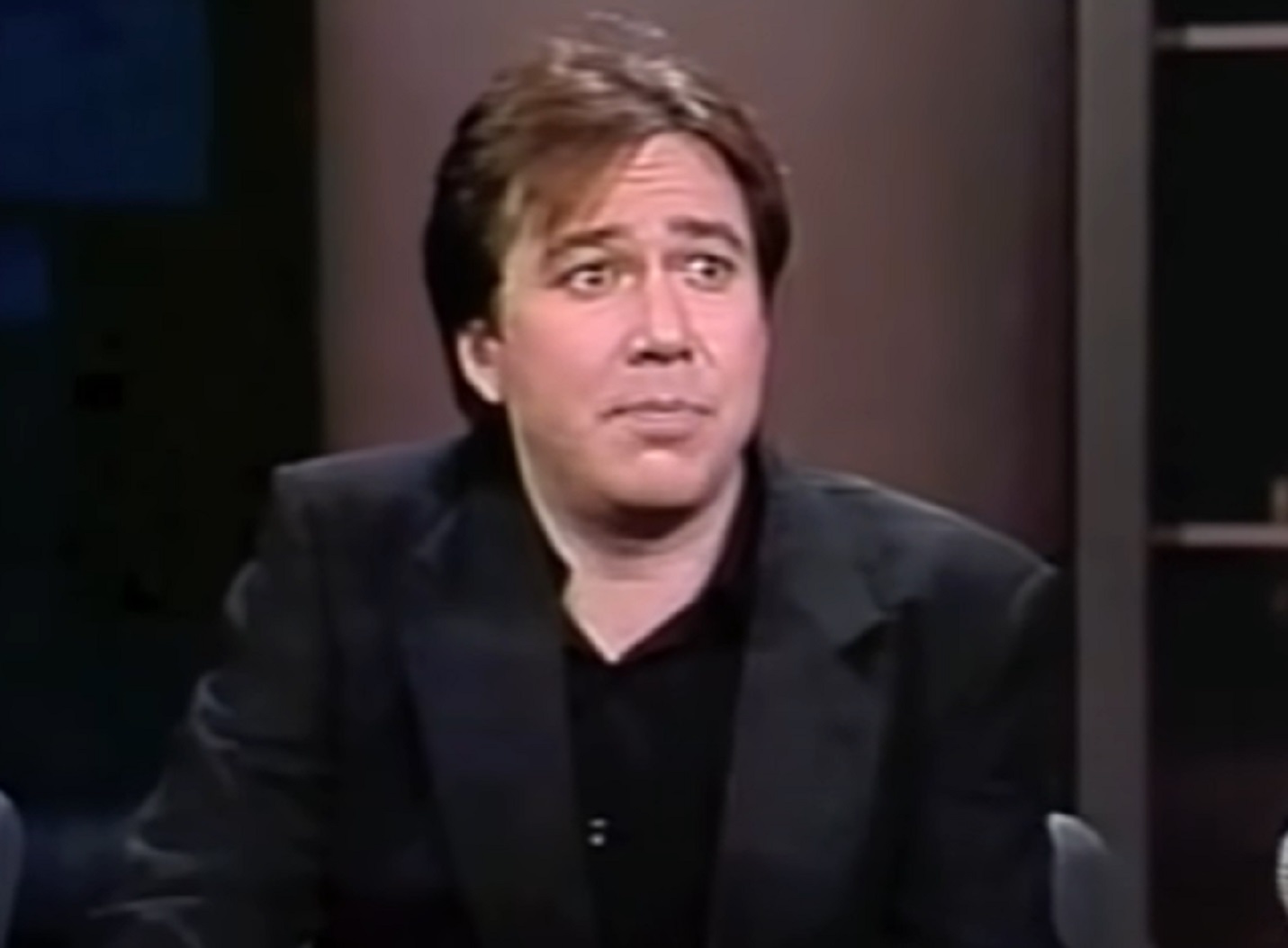 Screenshot: Bill Hicks is looking at side and thinking - from American- The Bill Hicks Story (2009).