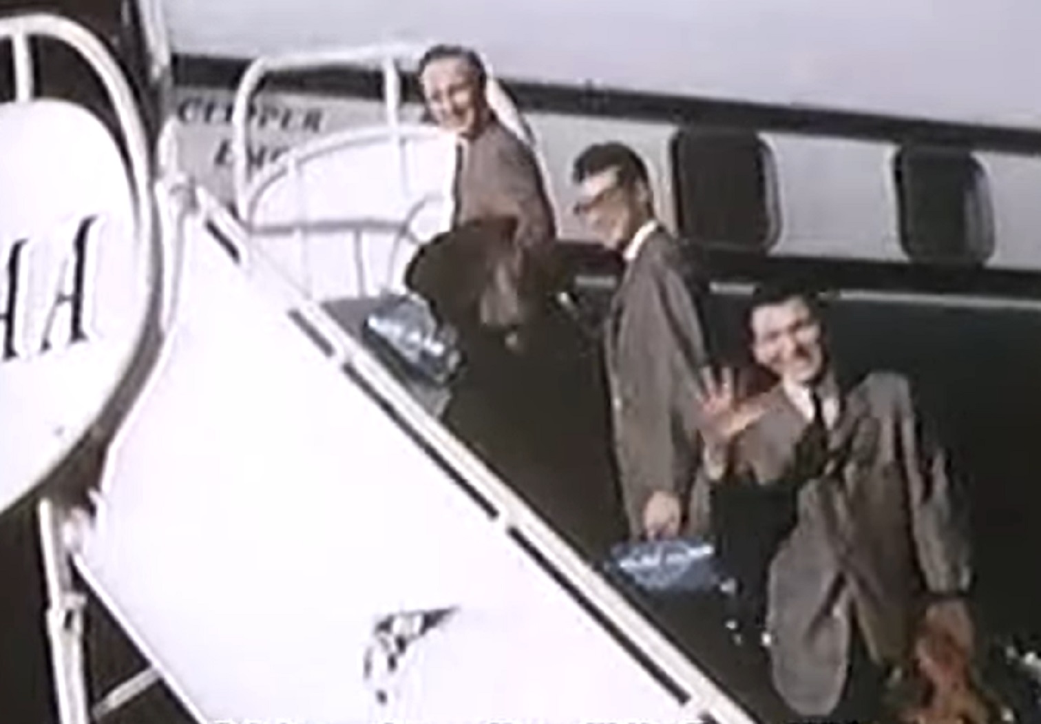 Screenshot: Buddy Holly with his band are getting in the plane and looking at side - from The Real Buddy Holly Story (1985).