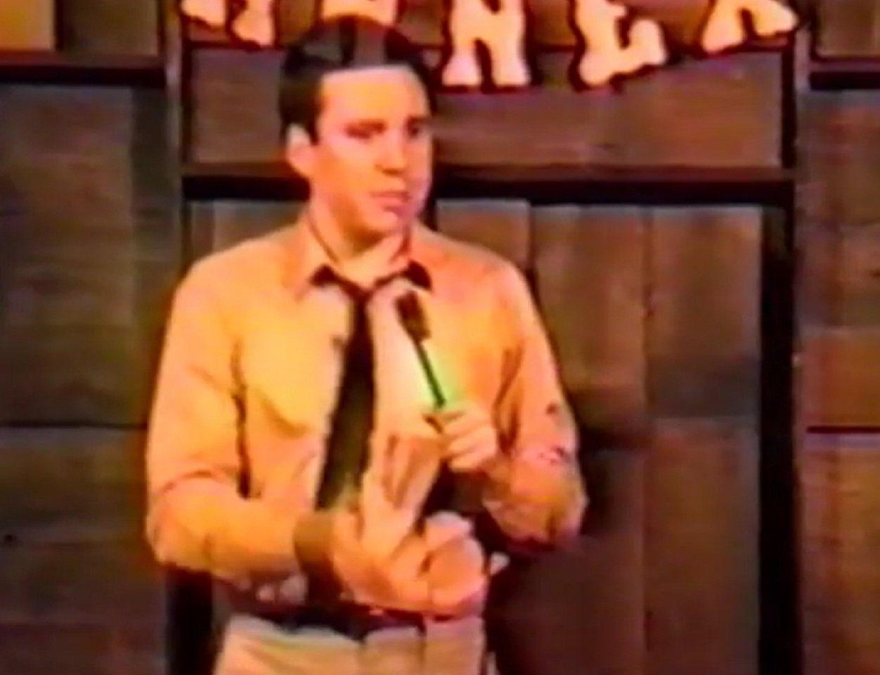 Screenshot: Bill Hicks is performing live on stage - from American- The Bill Hicks Story (2009).