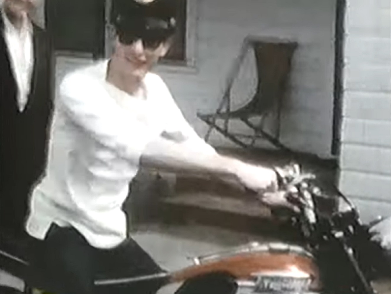 Screenshot: Buddy Holly is driving a bike - from The Real Buddy Holly Story (1985).