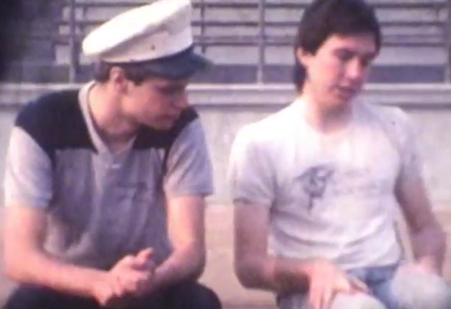 Screenshot: Dwight Slade and Bill Hicks are seating and talking outside - from American: The Bill Hicks Story (2009)