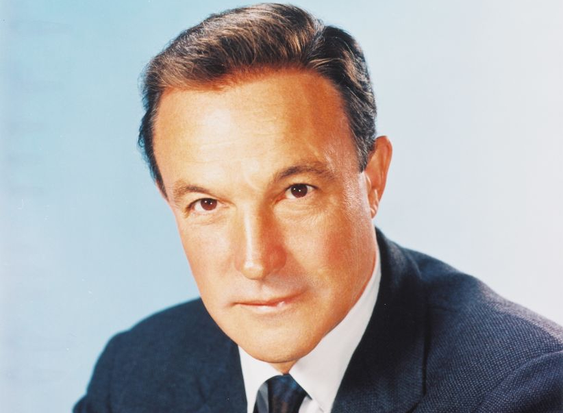 Headshot of Gene Kelly (1912-1996), US actor and dancer, wearing a dark blue jacket