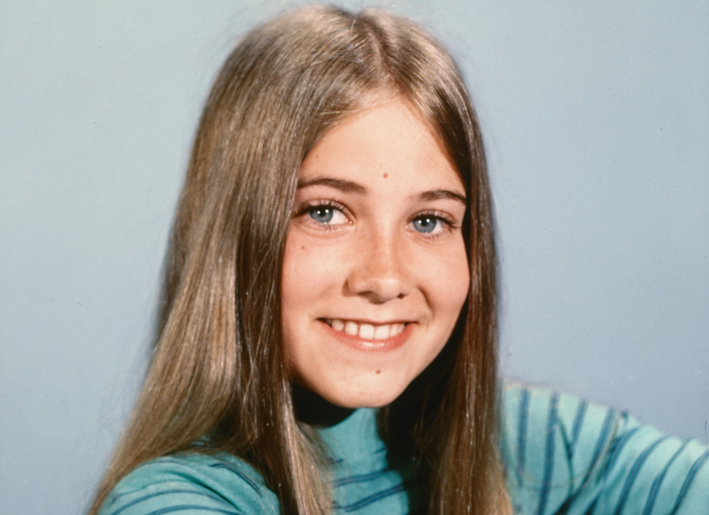 Maureen McCormick as  Marcia Brady  looking at the camera