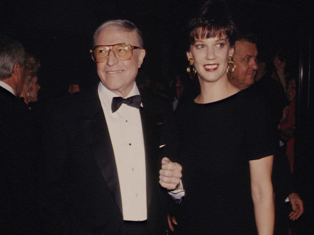 Gene Kelly and Patricia Ward at an event looking at the camera