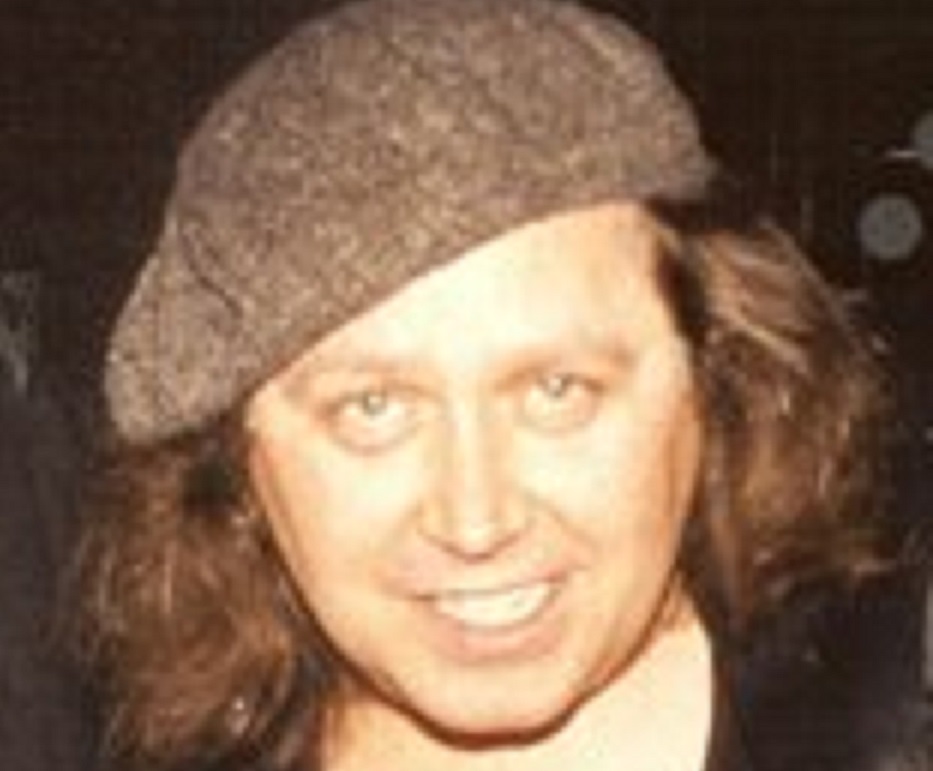 Portrait of Sam Kinison wearing brown hat and smiling at camera - circa 1980s