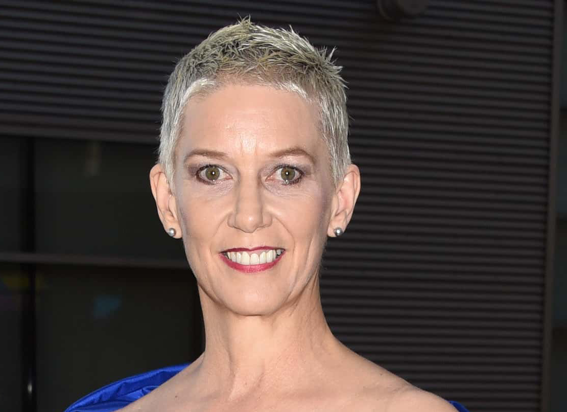 Patricia Ward in blue dress looking at the camera