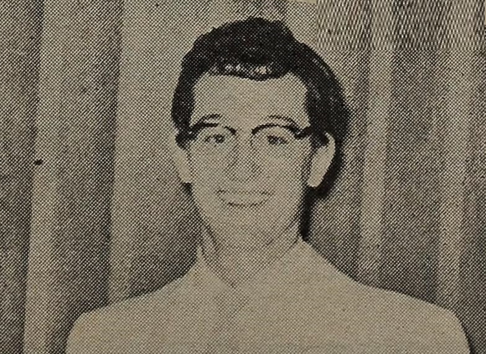 Buddy Holly wearing white shirt is smiling at camera - 1957