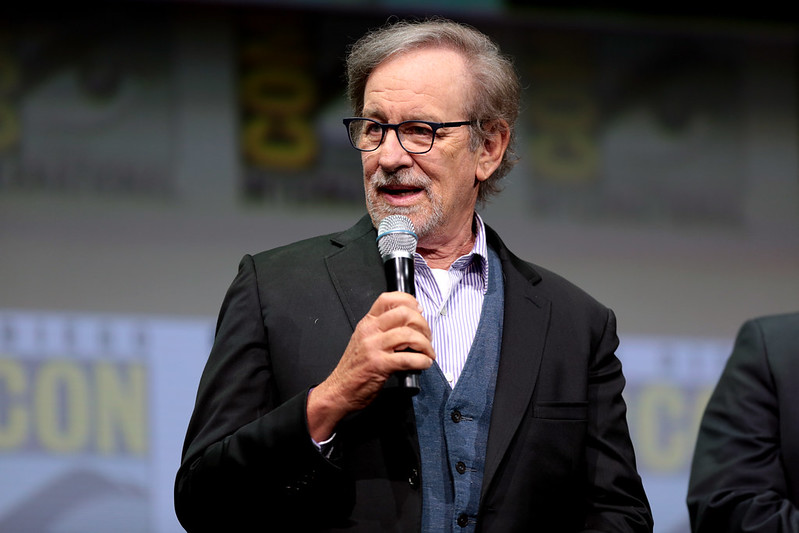 Steven Spielberg speaking at the 2017 San Diego Comic Con in suit looking at the camera