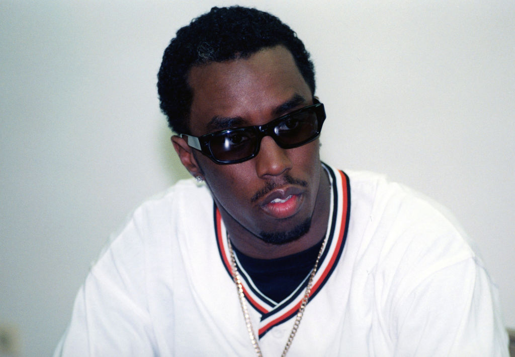 Rapper and producer Sean 'Puffy' Combs (Sean John Combs) in white looking at camera