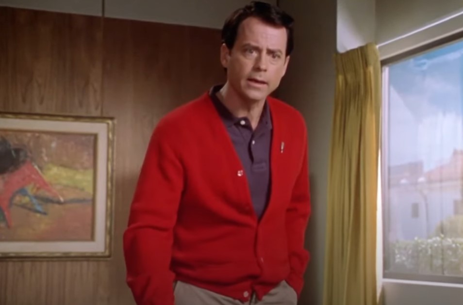 Greg Kinnear  as  Bob Crane in red sweater