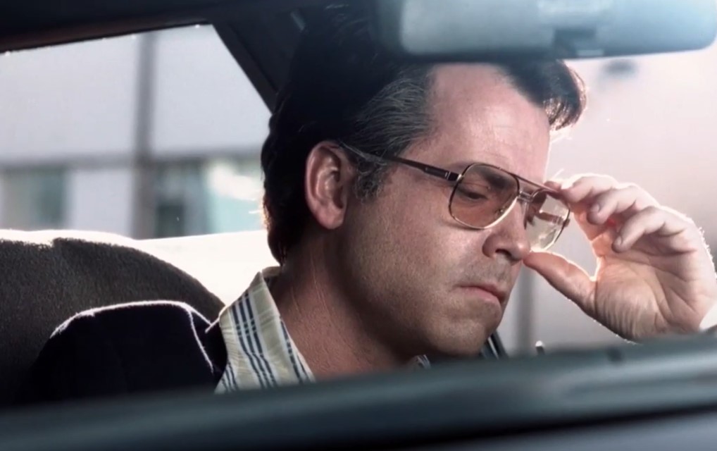 Greg Kinnear  as  Bob Crane in a car
